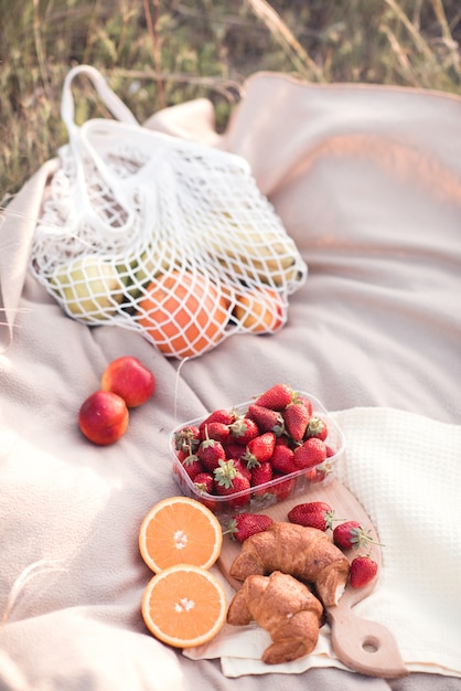 Picnic with fruits strawberry and chocolate croissants