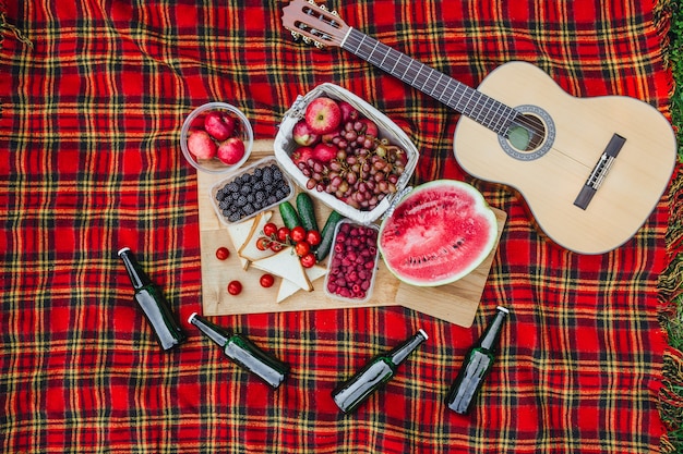 Picnic with watermelon and other fruits on nature, guitar, nobide