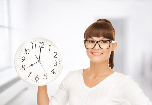 picture of attractive businesswoman with wall clock