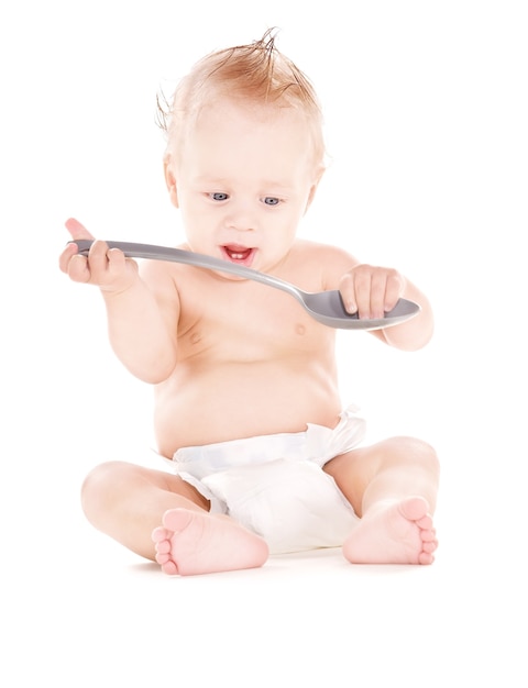 picture of baby boy with big spoon over white