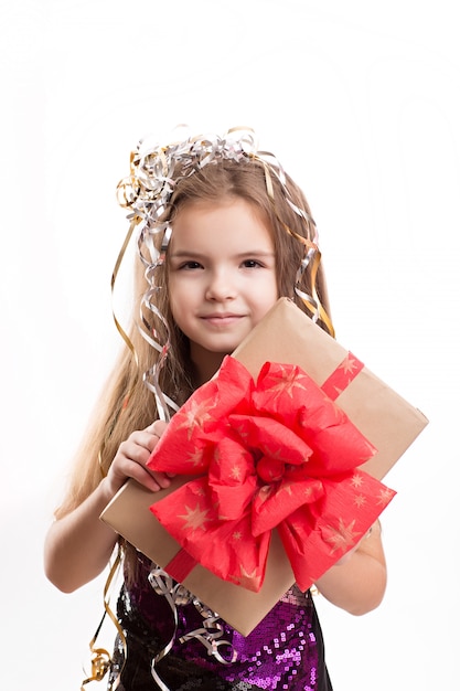 Picture of beautiful girl with gift box on white wall