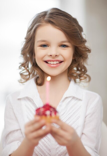 picture of beautiful pre-teen girl with cupcake