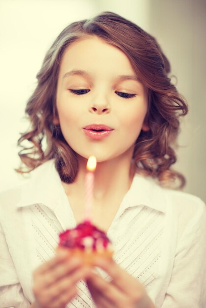 picture of beautiful pre-teen girl with cupcake