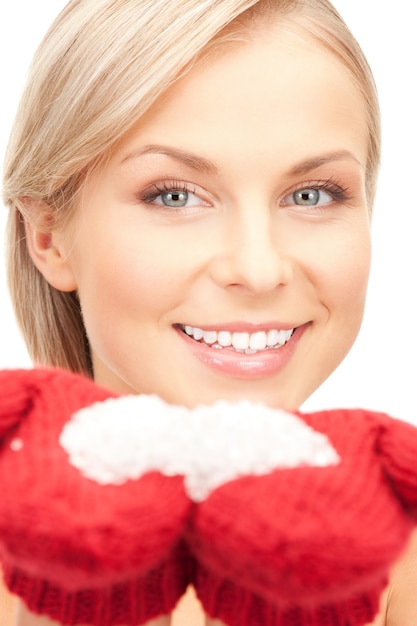 picture of beautiful woman in mittens with snow