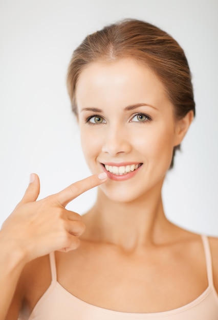 picture of beautiful woman pointing to teeth