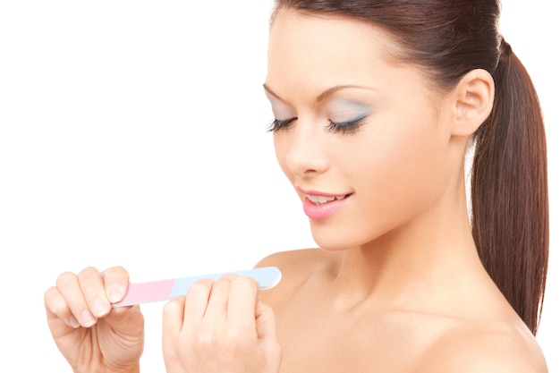 .picture of beautiful woman polishing her nails. .