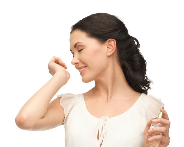 picture of beautiful woman smelling perfume on her hand