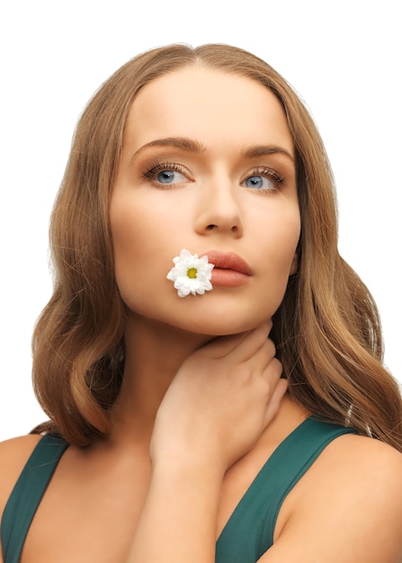 picture of beautiful woman with camomile in mouth