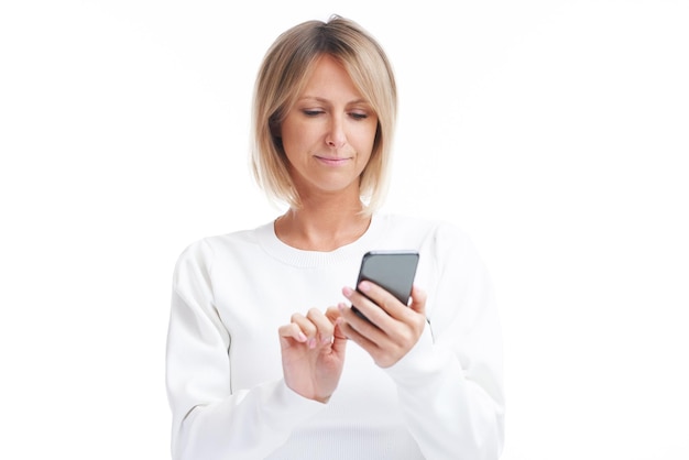 Picture of blonde woman over back isolated background with mobile phone