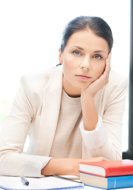 picture of bored and tired woman behid the table