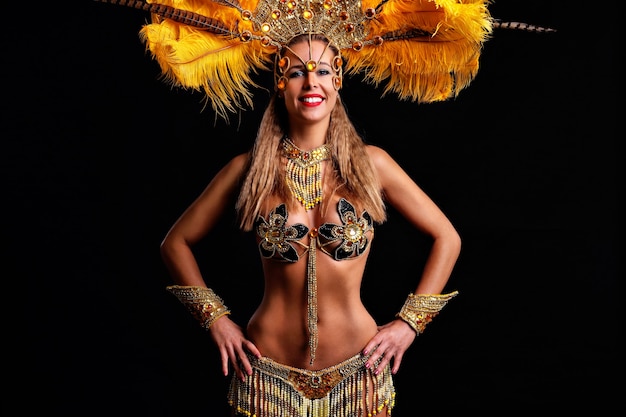 Picture of brazilian woman posing in samba costume on black