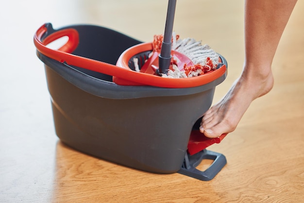 Picture of bucket and mop on the wooden floor