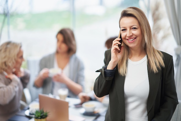 Picture of business woman with cell phone on meeting