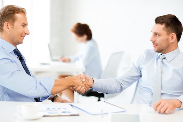 picture of businessmen shaking hands in office