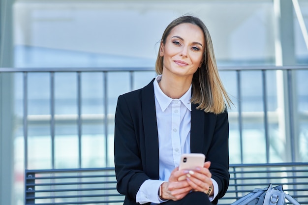 Picture of businesswoman sitting and waiting in the railway station