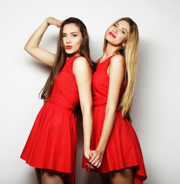 Picture of a charming young girls in red dress on white background