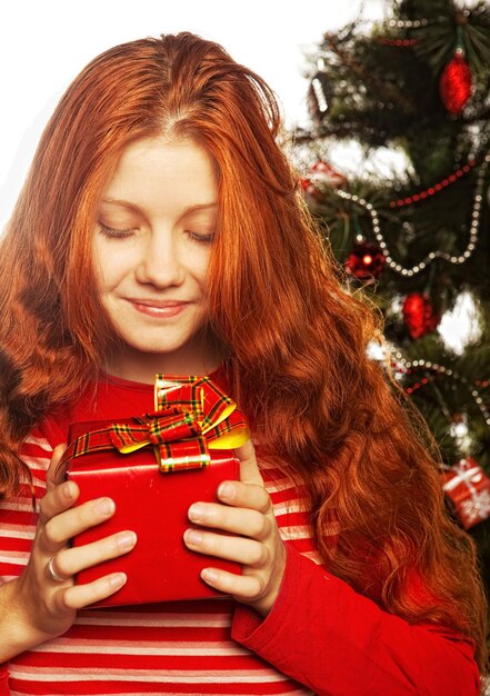 Picture of cheerful redhair girl with gift box Three background