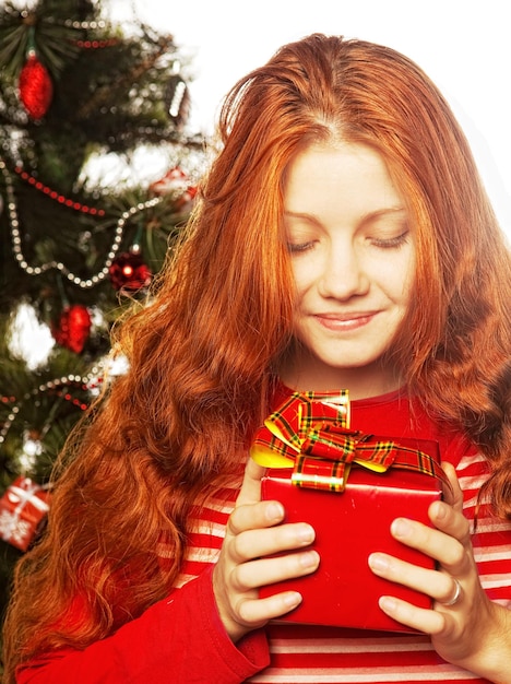 picture of cheerful redhair girl with gift box Three background