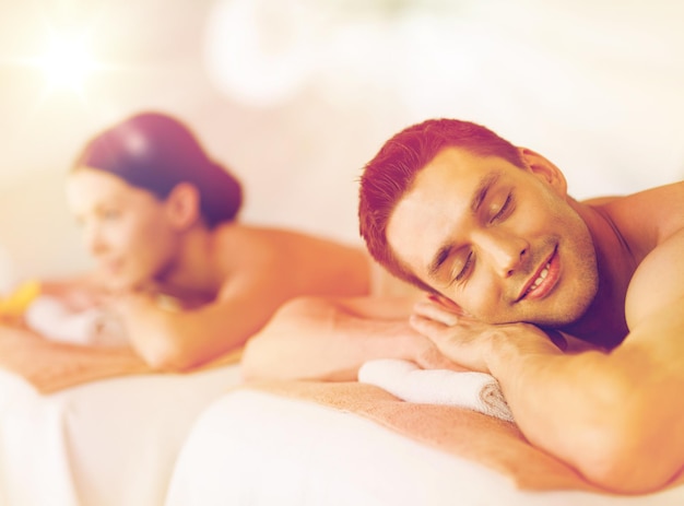 picture of couple in spa salon lying on the massage desks