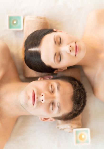 picture of couple in spa salon lying on the massage desks