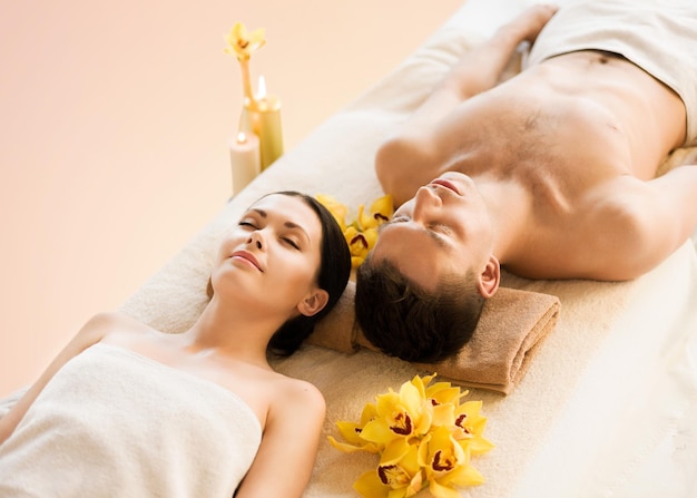 picture of couple in spa salon lying on the massage desks