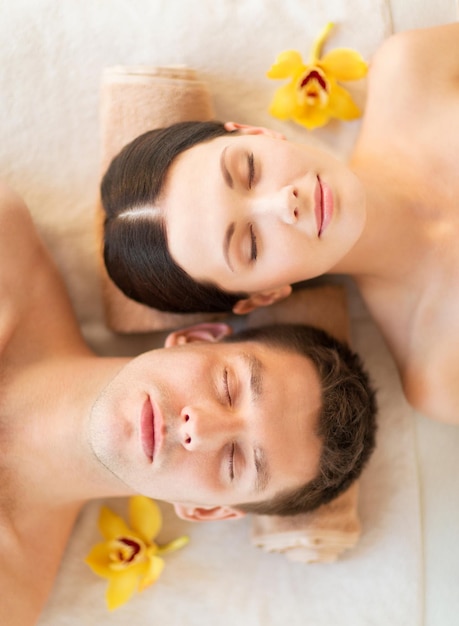 picture of couple in spa salon lying on the massage desks