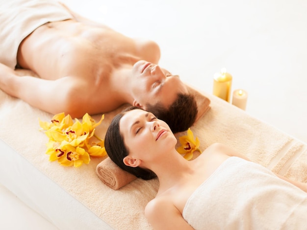 Picture of couple in spa salon lying on the massage desks