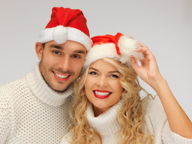 picture of family couple in sweaters and santa's hats