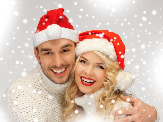 picture of family couple in sweaters and santa's hats