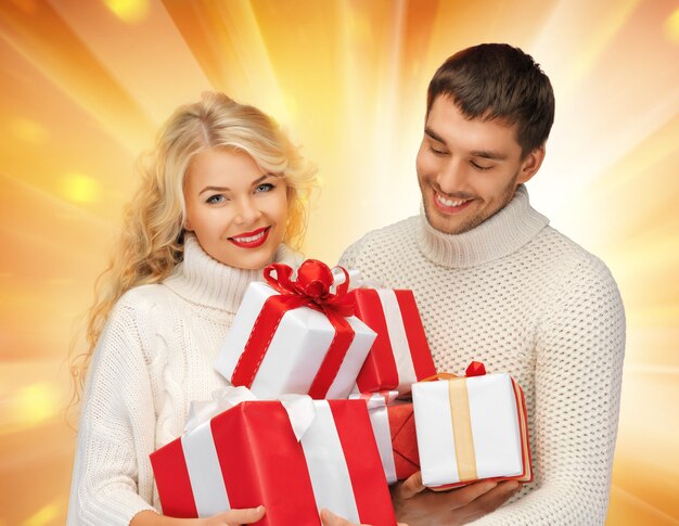 picture of family couple in a sweaters with gift boxes