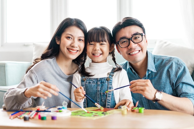 Picture of family sitting and painting together