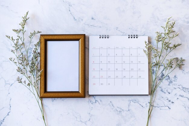 Picture frame and calendar and Caspia flower on marble