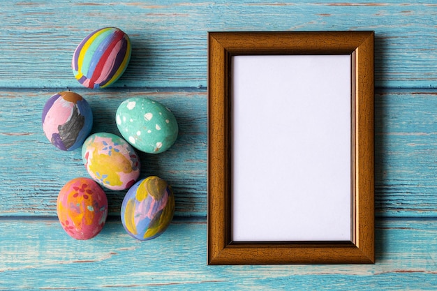 Picture frame and colorful easter eggs. Easter festive holidays concept.