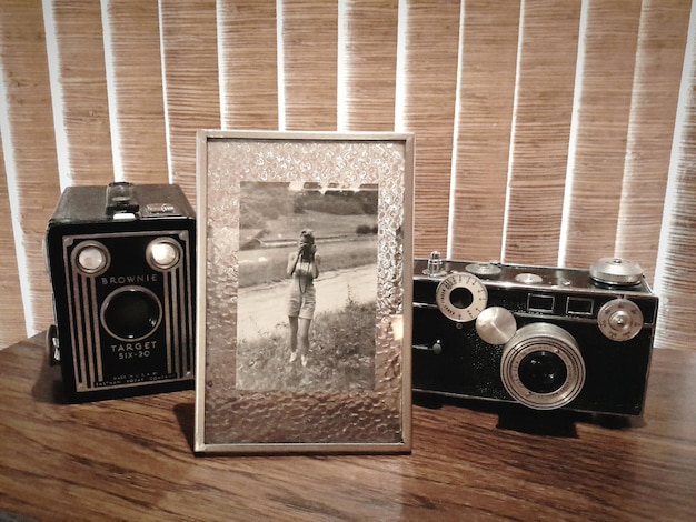 Photo picture frame and retro cameras on table