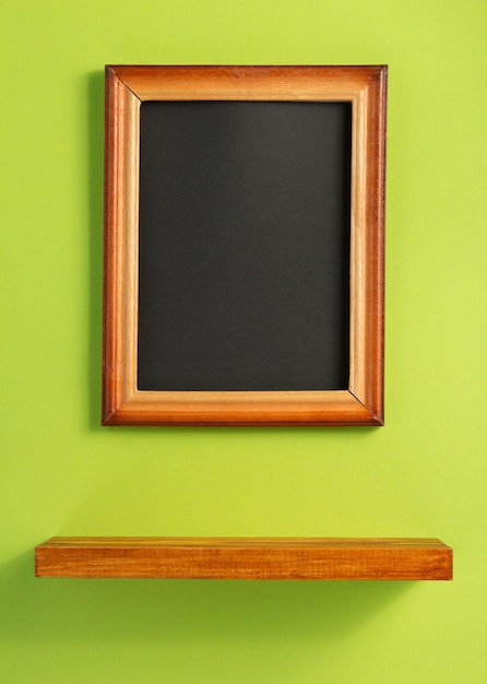 Picture frame and shelf at wall background