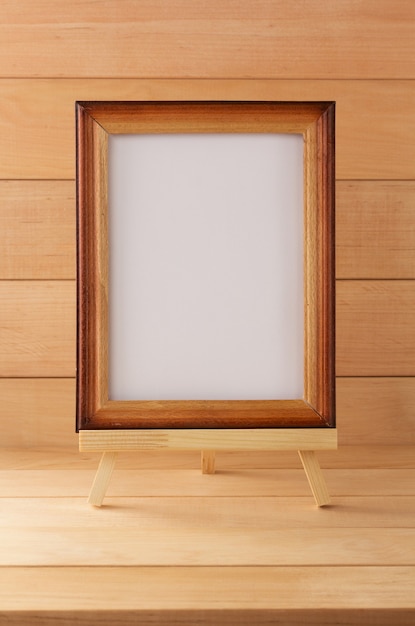 Picture frame on wooden background