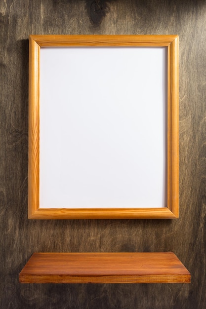 Picture frame at wooden background