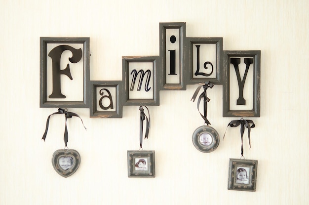 Photo picture frames with family text mounted on wall