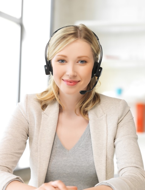 picture of friendly female helpline operator with headphones