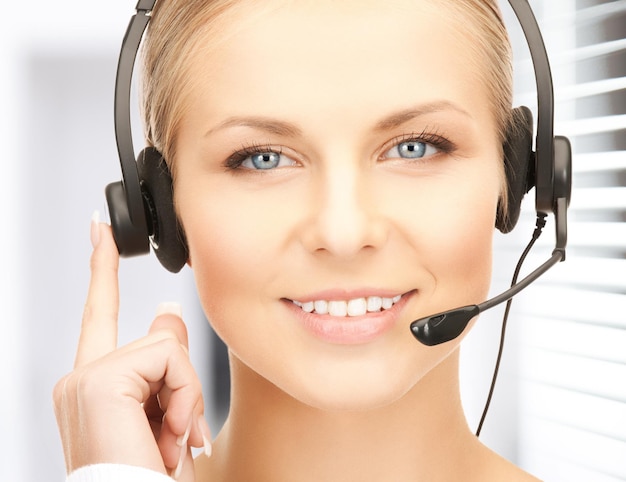 picture of friendly female helpline operator with headphones