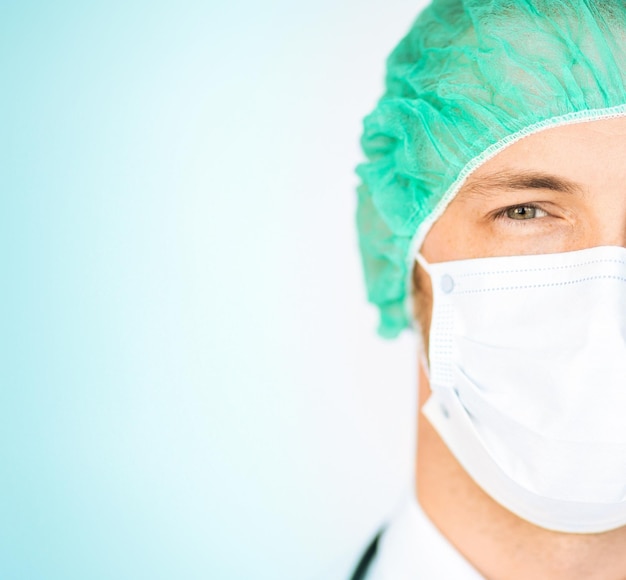 picture of half face of surgeon in medical cap and mask