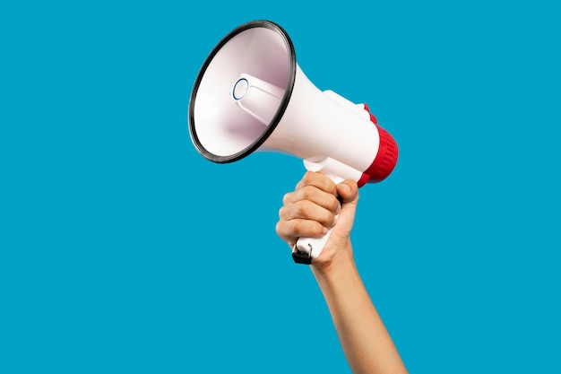 Picture of hand with mouthpiece on empty blue background