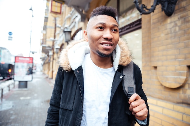 Picture of an handsome man walking on the street.