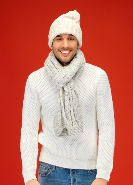 picture of handsome man in warm sweater, hat and scarf.