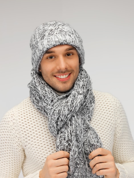 picture of handsome man in warm sweater, hat and scarf.