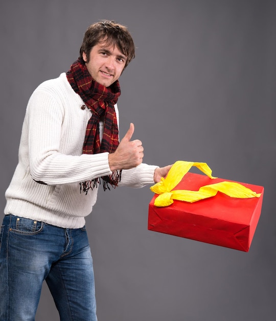 Picture of handsome man with a present box