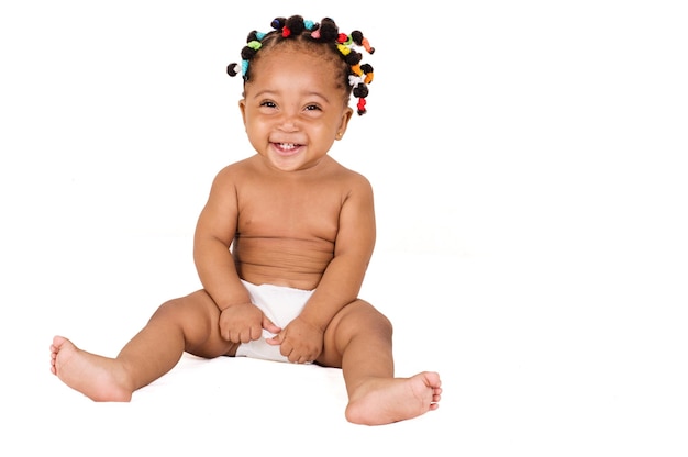 Photo picture of happy baby girl sitting and drawing her diaper