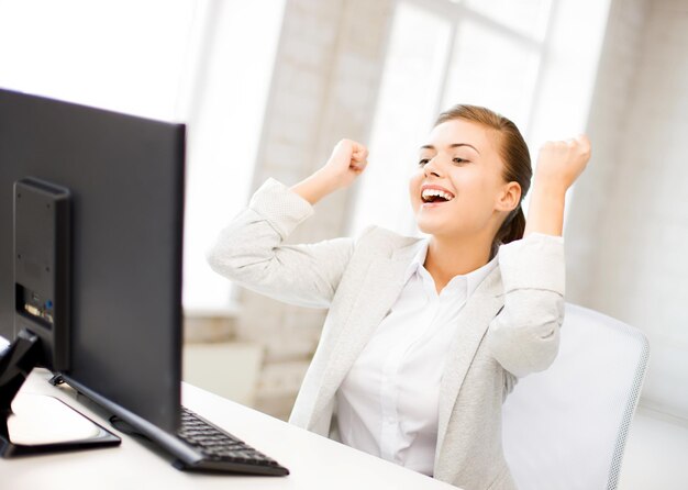 picture of happy businesswoman with computer in office