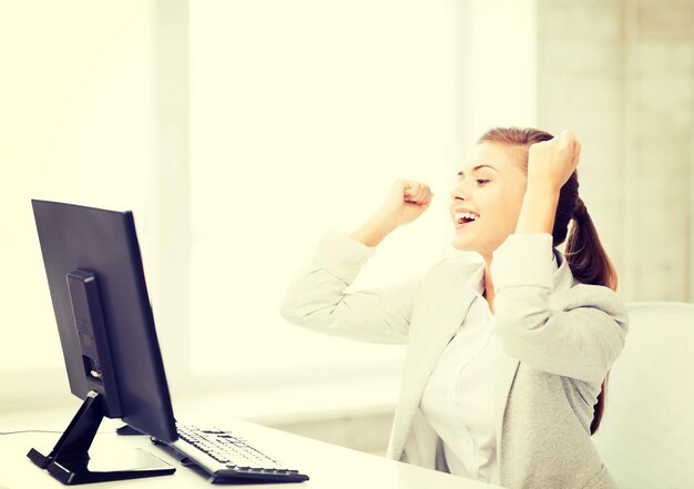 picture of happy businesswoman with computer in office