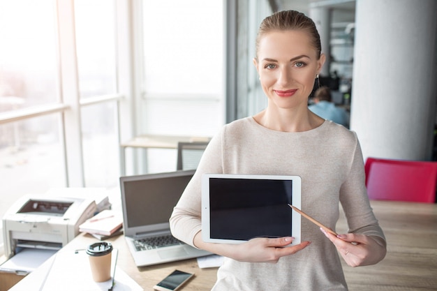 A picture of happy and cheerful woman having laptop in her hands